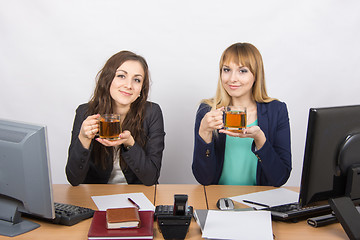 Image showing Tea Break two office employees at the desk