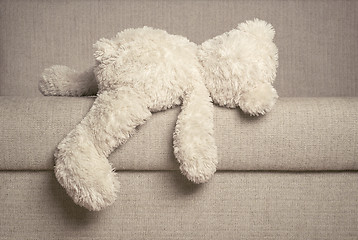 Image showing Teddy bear is laying on the sofa