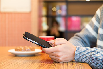 Image showing Woman typing on mobile phone