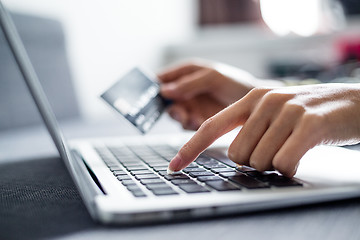 Image showing Woman holding credit card on laptop for online shopping