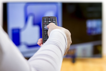 Image showing Closeup on woman hand holding remote control