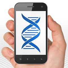 Image showing Health concept: Hand Holding Smartphone with DNA on display