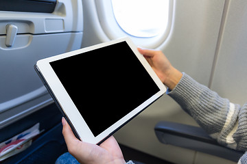 Image showing Woman use of the digital tablet in plane