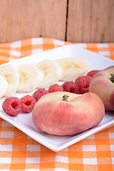 Image showing peach raspberries bananas close up as health food concept