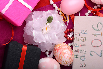 Image showing Easter eggs and flowers on background with gift box
