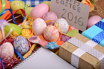 Image showing hand made eggs at a gift box, happy easter invitation card