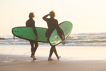 Image showing Surfers on beach with surfboard.