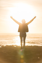 Image showing Free woman enjoying freedom on beach at sunset.