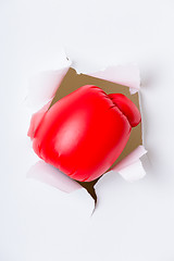 Image showing Hand through the hole in paper with boxing gloves