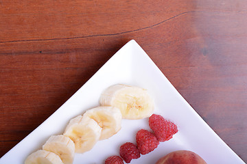 Image showing peach raspberries bananas close up as health food concept