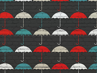 Image showing Protection concept: Umbrella icons on wall background