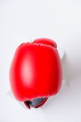 Image showing Hand in boxing glove through paper hole