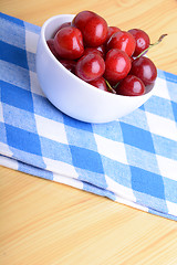 Image showing Red ripe cherries in a white bowl