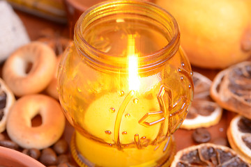 Image showing Coffee beans on a black background with candle. Raw coffee beans and fire from candle