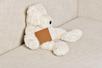 Image showing Teddy bear is sitting on the sofa