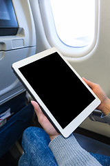 Image showing Woman using digital tablet on in plane