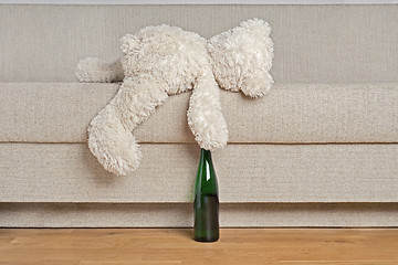 Image showing Teddy bear is laying on the sofa