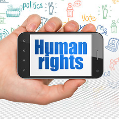 Image showing Politics concept: Hand Holding Smartphone with Human Rights on display