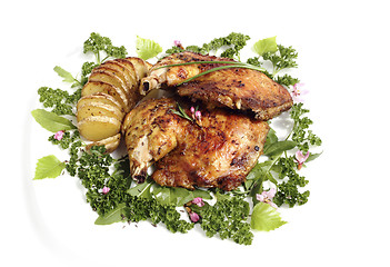 Image showing Fried chicken thighs with roast potatoes hasselback