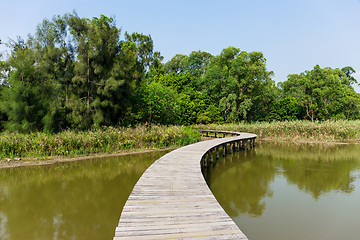 Image showing Wooden footbridge across river