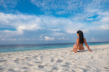 Image showing Girl walking along a tropical beach in the Maldives.