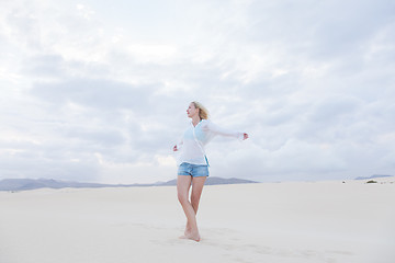 Image showing Carefree woman enjoying freedom on beach.