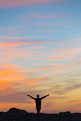 Image showing Woman enjoying freedom at sunset.