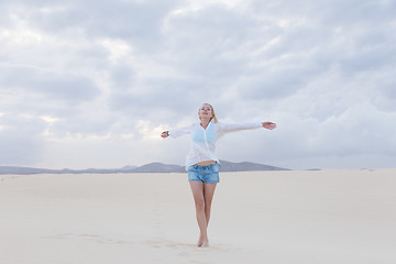 Image showing Carefree woman enjoying freedom on beach.