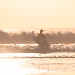 Image showing Surfers on beach with surfboard.