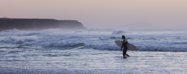 Image showing Surfers on beach with surfboard.