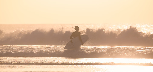 Image showing Surfers on beach with surfboard.