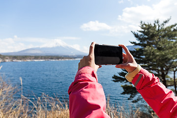 Image showing Woman take the photo by cellphone for Mountain Fuji