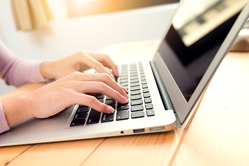 Image showing Woman typing report on notebok computer