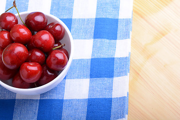 Image showing Red ripe cherries in a white bowl