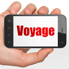 Image showing Travel concept: Hand Holding Smartphone with Voyage on display