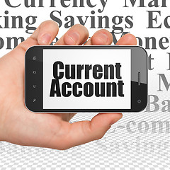 Image showing Currency concept: Hand Holding Smartphone with Current Account on display
