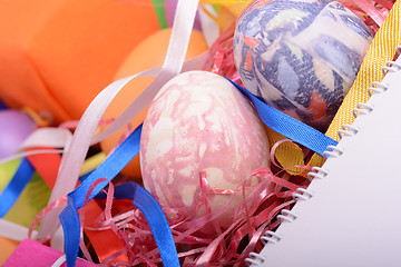 Image showing Arrangement of Gift Boxes in Wrapping Paper with Checkered Ribbons and Decorated Easter Eggs