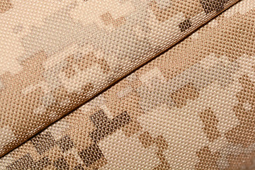 Image showing close up of worn out olive green tone camouflage fabric