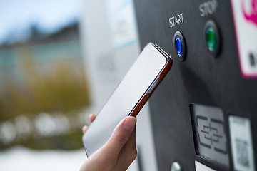 Image showing Customer paying though NFC on parking machine