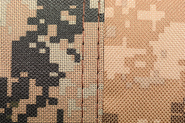 Image showing close up of worn out olive green tone camouflage fabric