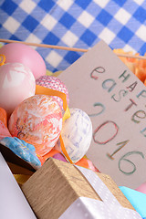 Image showing hand made eggs at a gift box, happy easter invitation card