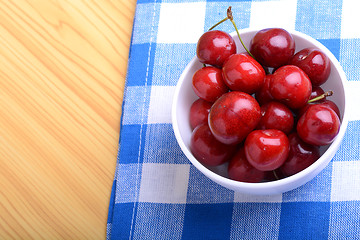 Image showing Red ripe cherries in a white bowl