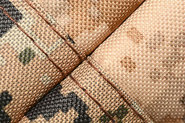 Image showing close up of worn out olive green tone camouflage fabric