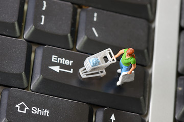Image showing Online shopping with shopper on a keyboard