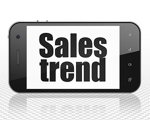 Image showing Advertising concept: Smartphone with Sales Trend on display