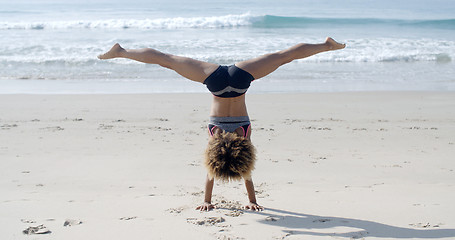 Image showing Girl Doing A Handstand On A Beach