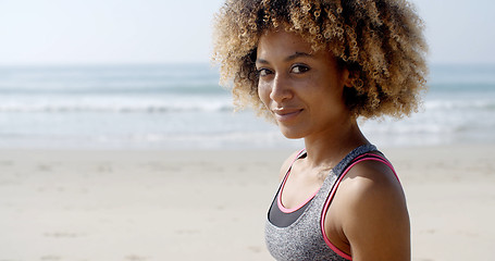 Image showing Fit Woman Sits On The Beach