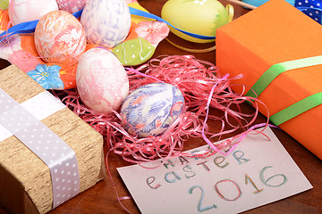 Image showing Happy Easter invitation card, hand made eggs at a gift box