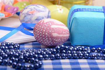 Image showing Assorted Easter coloured eggs in the paper egg box