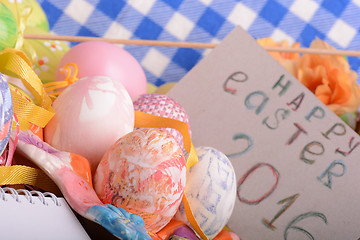 Image showing hand made eggs at a gift box, happy easter invitation card